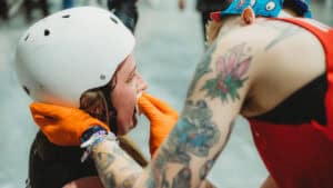 An image of a medic performing first aid for a skater with a bloody nose.
