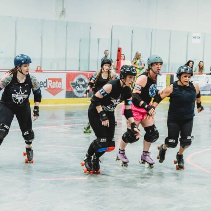 An image of Springfield Roller Derby skaters on the track.